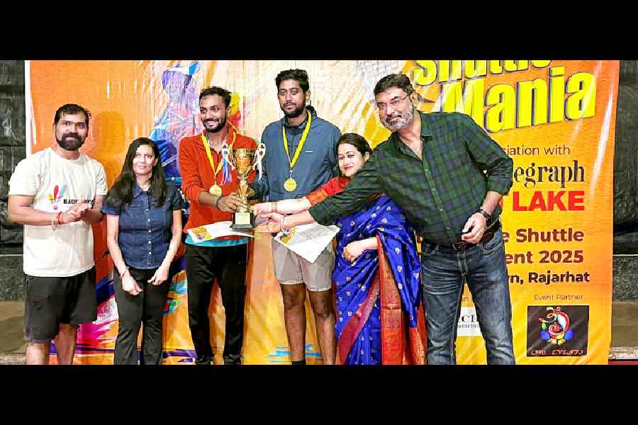 The men’s doubles open champions receive their prizes