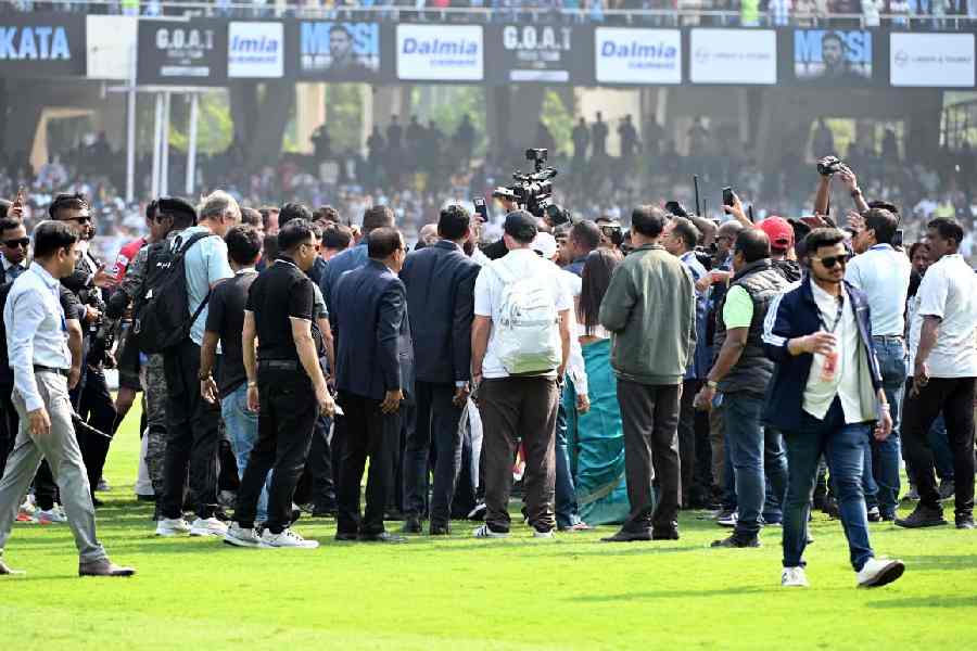 FINDING MESSI: A heavy security ring of organisers, police, political leaders and media surrounds Lionel Messi during his appearance at Salt Lake Stadium, leaving the football icon out of view. The overwhelming presence of officials and associates eclipsed the moment for the fans gathered at the venue. 