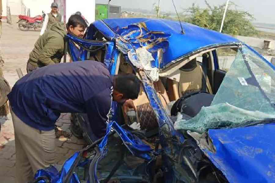 A forensic team on Thursday examines the car involved in the crash