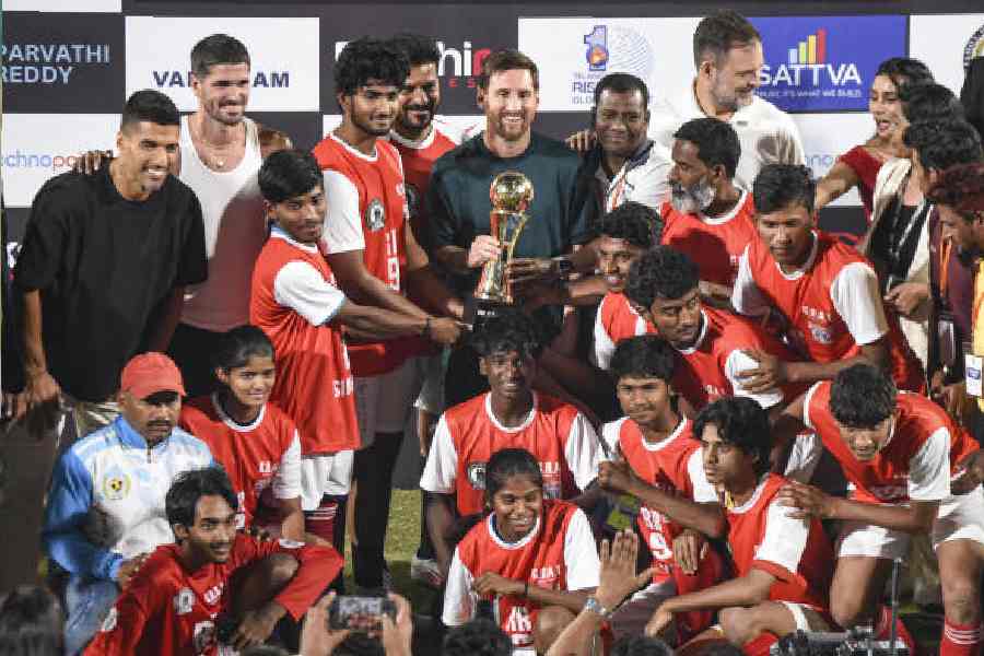 Lionel Messi with a local football team in Hyderabad on Saturday.