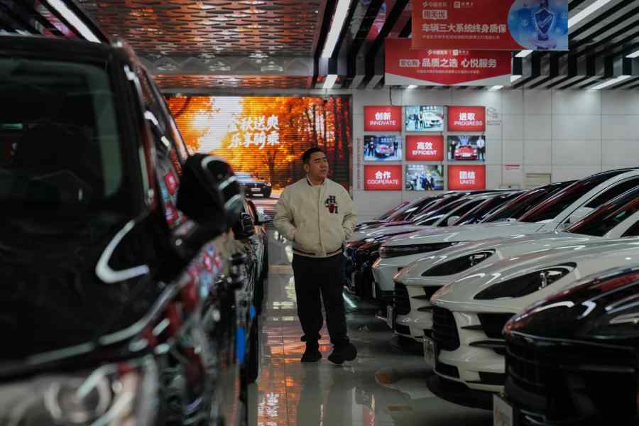 A man walks inside a second hand market for luxury cars in Beijing, November 25, 2025.