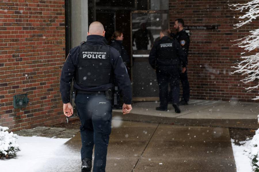 A Police officer walks towards the Barus & Holley engineering building, at the site of Saturday's mass shooting at Brown University in Providence, Rhode Island, U.S. December 14, 2025.