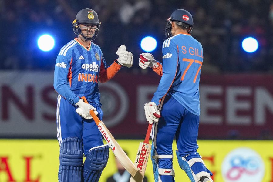 India's Shubman Gill, right, and Abhishek Sharma greet each other between the wickets during the third T20 International cricket match of a series between India and South Africa, at HPCA Stadium, in Dharamshala, Himachal Pradesh, Sunday, Dec. 14, 2025.