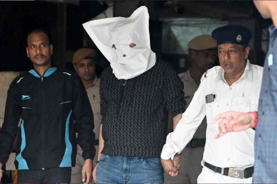 Organiser Satadru Dutta being brought to Bidhannagar court on Sunday.