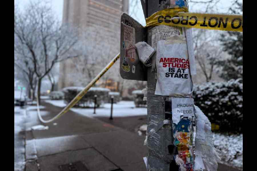 An ‘America study is at stake’ sign is attached to a pole at the site of the mass shooting at Brown University on Sunday.