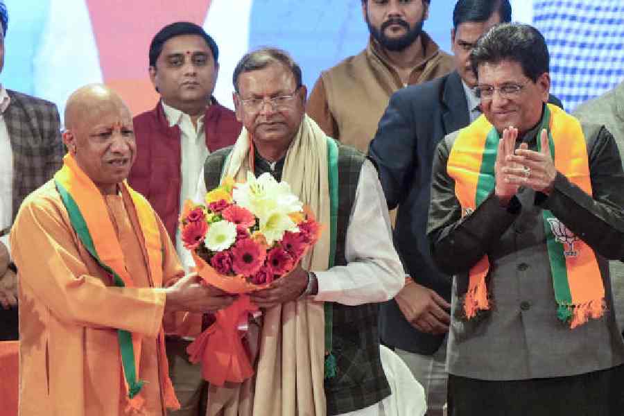 Pankaj Chaudhary (right) with Yogi Adityanath at an event in Lucknow on Sunday.