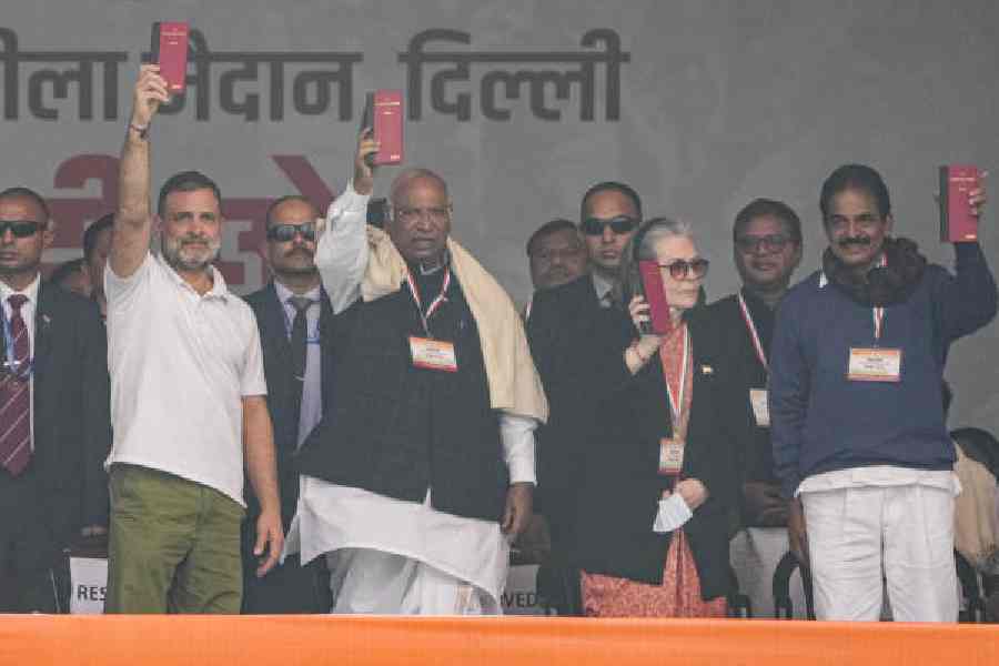 (From left) Rahul Gandhi, Mallikarjun Kharge, Sonia Gandhi and parliamentarian KC Venugopal hold up copies of the Constitution during the rally in New Delhi on Sunday. 