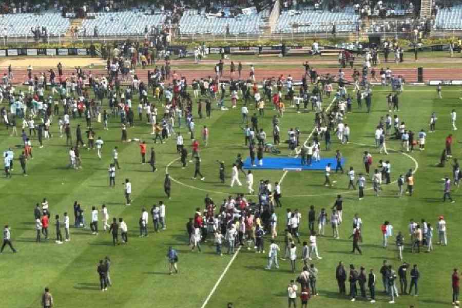 Salt Lake Stadium looks like a picnic hot spot as Lionel Messi fans roam around on the pitch on Saturday.