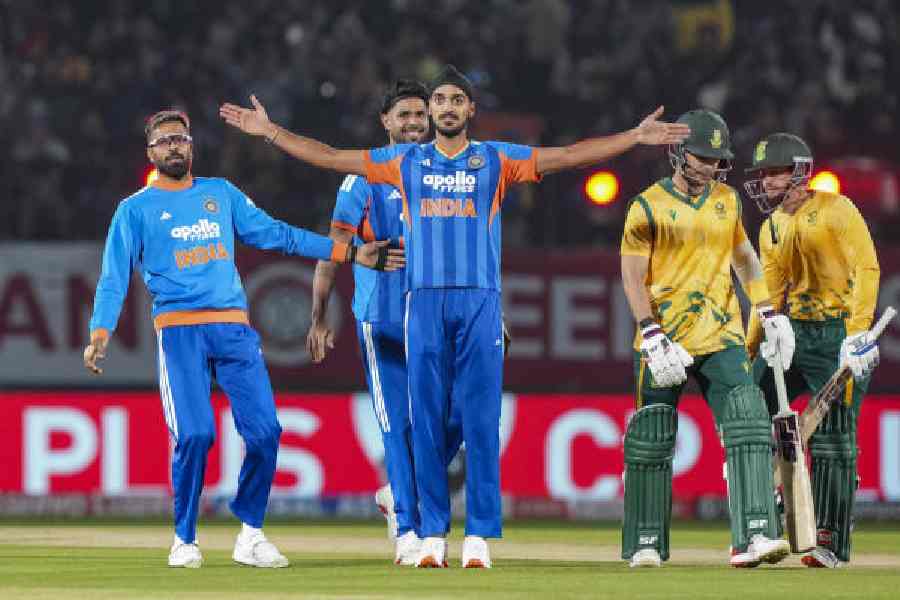 Arshdeep Singh (centre) celebrates the wicket of Reeza Hendricks with his teammates in Dharamsala on Sunday. The left-arm pacer conceded just 13 runs in his four overs while also taking two wickets.