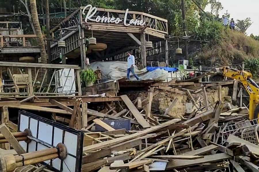 An excavator demolishes wooden structures at Romeo Lane on Anjuna beach after a fire at the adjacent Birch by Romeo Lane nightclub killed 25 people, as the state administration begins pulling down the tourism property, in Goa, Tuesday, Dec. 9, 2025.