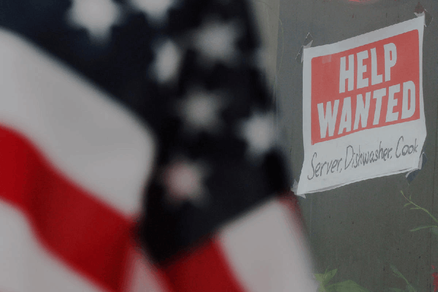 File photo: A “Help Wanted” sign hangs in restaurant window in Medford, Massachusetts