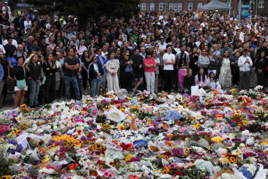 People pay respects to the victims of the shooting at Bondi Pavilion in Sydney on Monday.