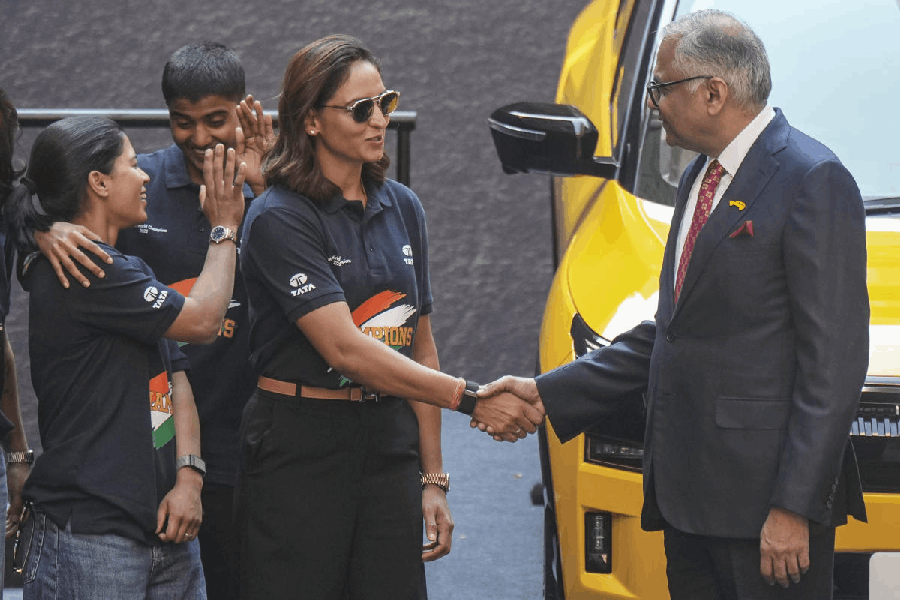 Women's cricket captain Harmanpreet Kaur shakes hands with Chairperson of Tata Motors Natarajan Chandrasekaran, during a felicitation event, in Mumbai, Tuesday, Dec. 16, 2025.