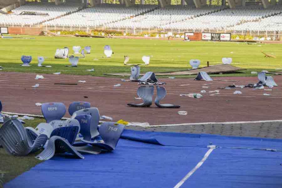 Broken plastic seats and water bottles lie scattered on the track and field after Saturday’s vandalism at the Salt Lake Stadium. Picture by Bishwarup Dutta