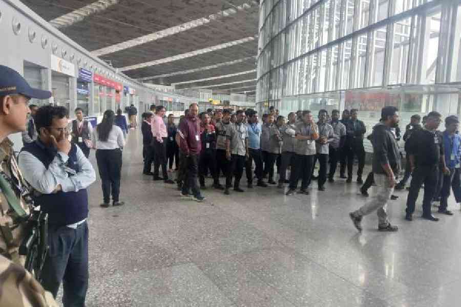 Contractual employees protest in front of the airport manager’s office at gate 3C on the departure level of the terminal on Tuesday