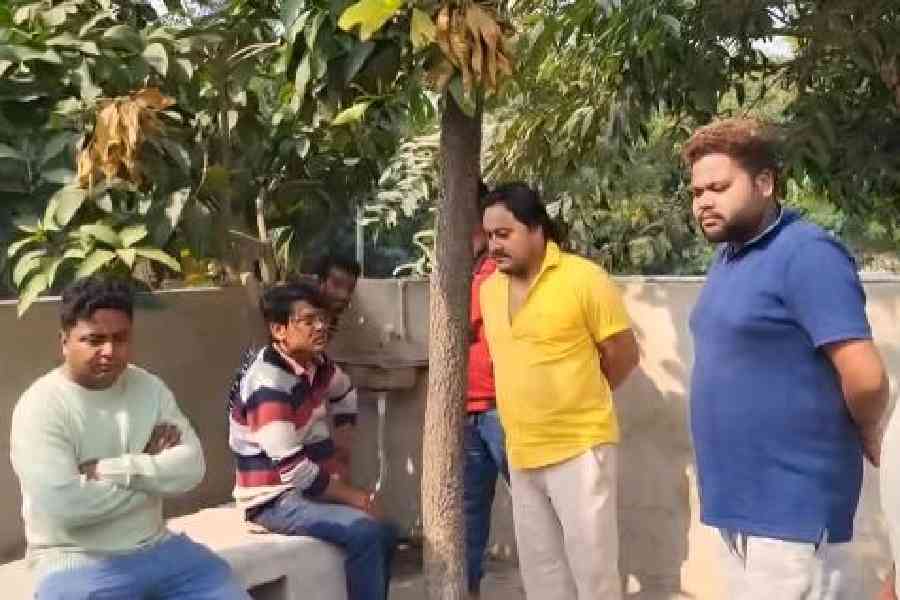 Trinamool councillor Surya Dey (left) at the crematorium in Dankuni on Tuesday. Picture by Amit Karmakar