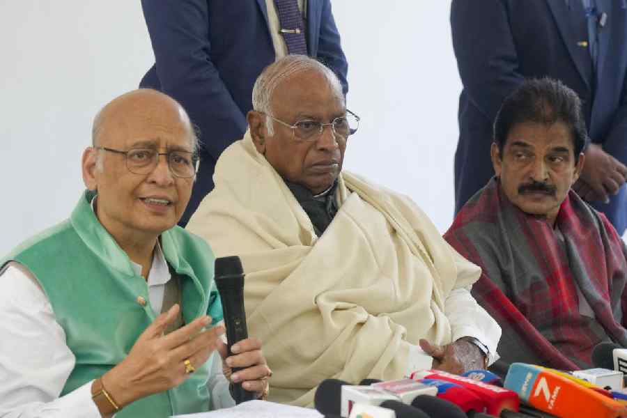 From left, Congress leader Abhishek Manu Singhvi, party President Mallikarjun Kharge and party leader KC Venugopal address a press conference, in New Delhi, Wednesday, Dec. 17, 2025.