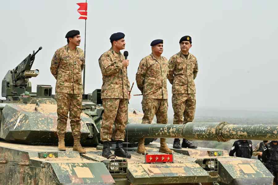 Chief of Army Staff of Pakistan Asim Munir holds a microphone during his visit at the Tilla Field Firing Ranges (TFFR) in Mangla, Pakistan May 1, 2025.