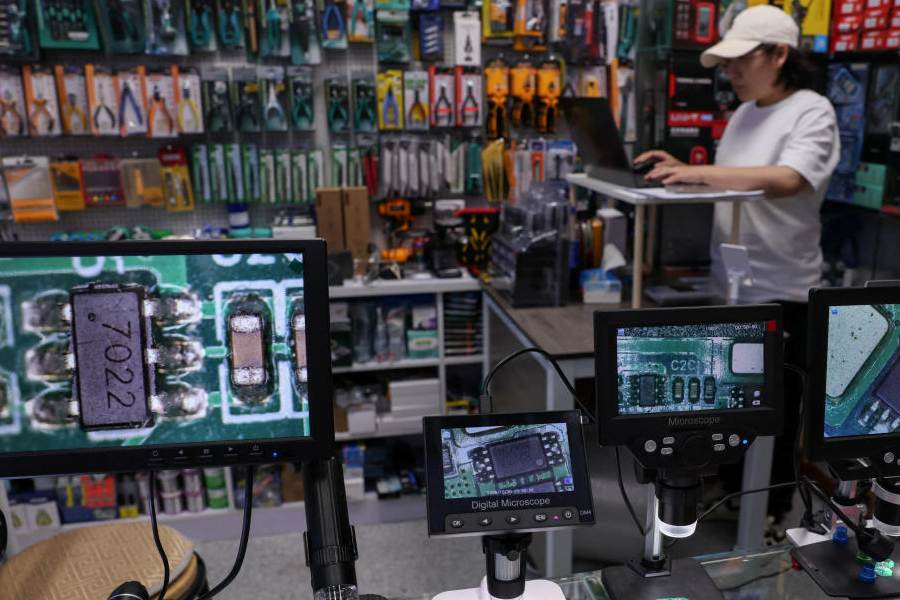 Magnifier screens show chips at a booth in a mall of Huaqiangbei electronics market in Shenzhen, Guangdong province, China October 30, 2025.