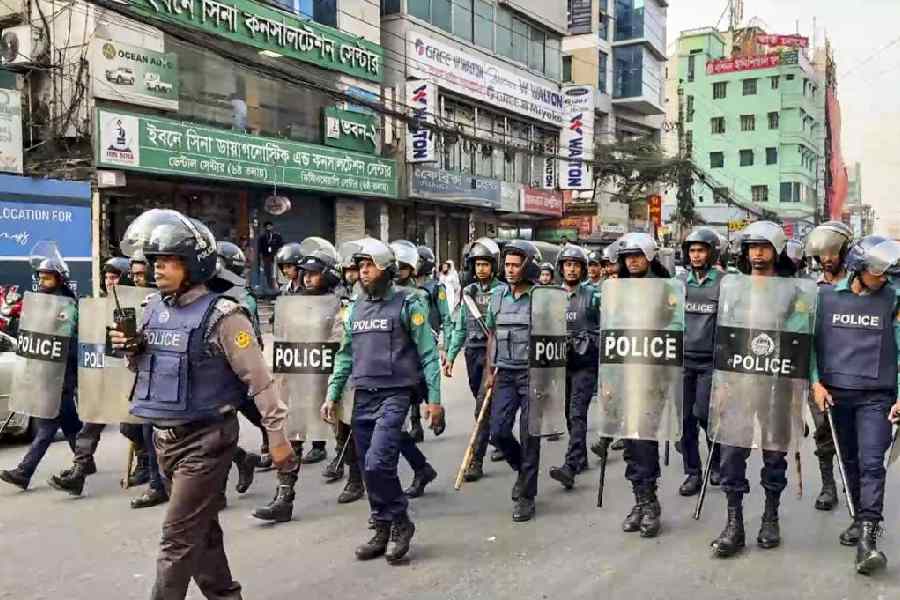 Security personnel outside the Indian high commission as protesters gather for a march in Dhaka on Wednesday.