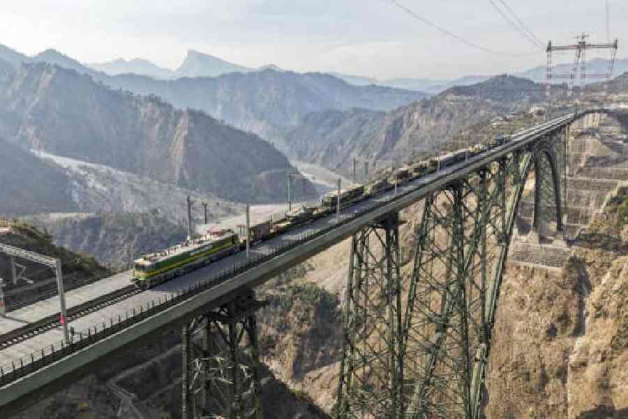 A military special train carrying tanks and artillery guns chugs through the Chenab bridge in Jammu and Kashmir on Tuesday. 