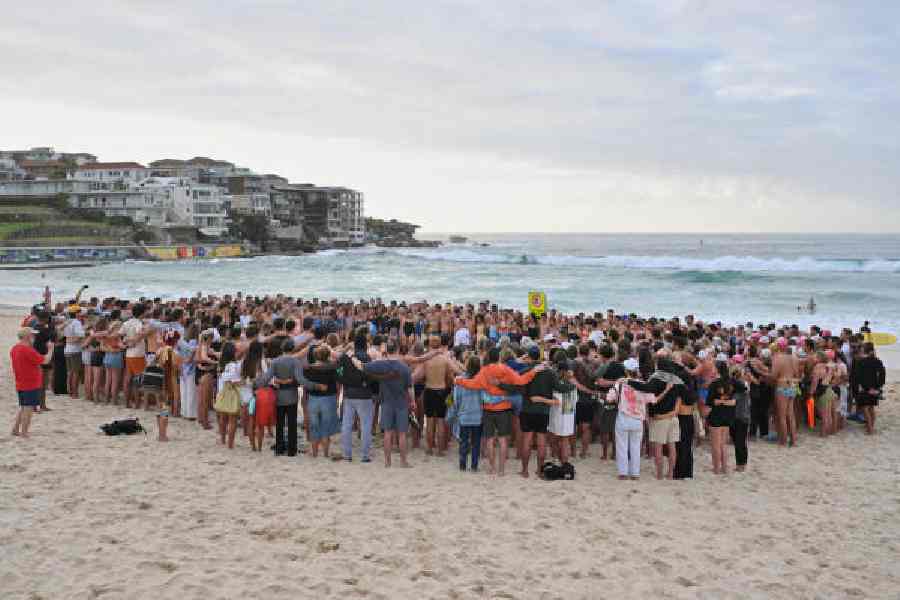 Swimmers gather for a morning vigil in Sydney on Wednesday.