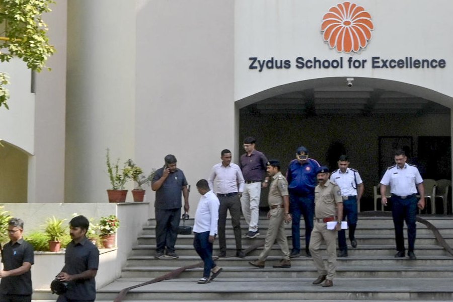 Police and bomb disposal squad dog personnel conduct a search operation at Zydus School after multiple schools in the city received bomb threat emails, in Ahmedabad, Wednesday, Dec. 17, 2025.