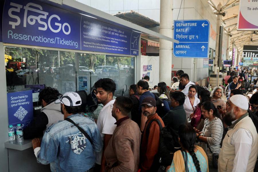 Passengers wait outside the IndiGo airlines ticketing counter at the Chhatrapati Shivaji Maharaj International Airport, after several IndiGo airlines flights were cancelled, in Mumbai, India, December 6, 2025.