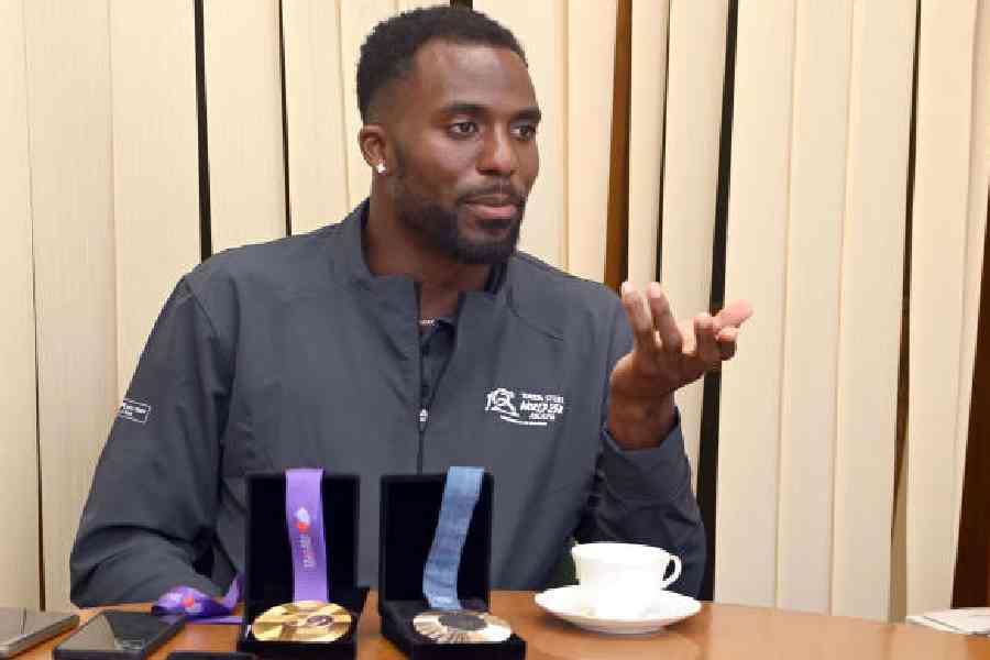 Double Olympic medallist sprinter Kenny Bednarek, the international event ambassador of the Tata Steel World 25K Kolkata 2025, partnered by The Telegraph, in Calcutta on Thursday. Displayed before the athlete are his 2024 Paris Olympics 200m silver medal and the 4x100m relay gold medal from the 2025 World Championships in Tokyo.
