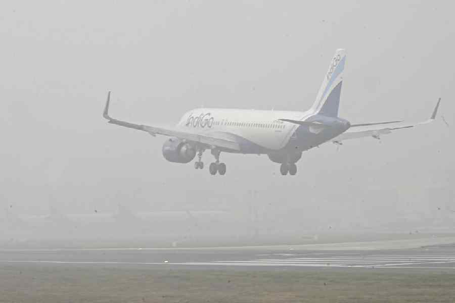 An airplane lands at Jay Prakash Narayan International Airport amid fog and low visibility, in Patna, Thursday, Dec. 18, 2025.
