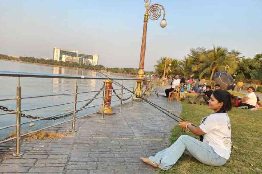 Women sit by the Eco Park lake for the angling competition. Picture by Brinda Sarkar