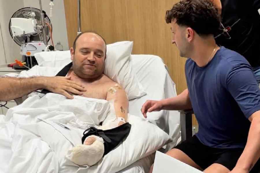 Influencer Zachery Dereniowski gives a donation check to Ahmed Al-Ahmed, the hero at Bondi Shooting