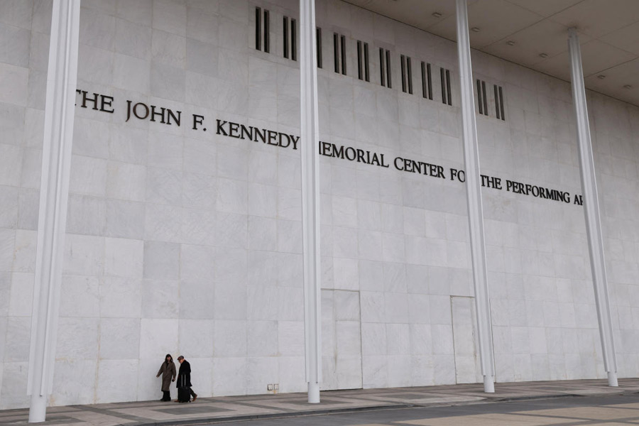 People walk along the front of the John F. Kennedy Center for the Performing Arts, after White House spokeswoman Karoline Leavitt announced that the Kennedy Center board decided to rename the institution the Trump-Kennedy Center in Washington, D.C., U.S., December 18, 2025.