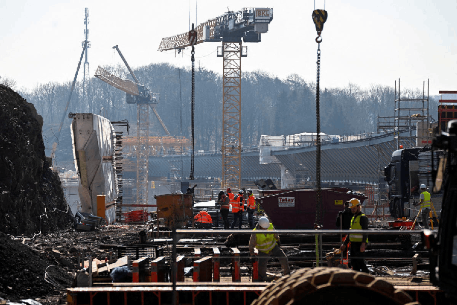 File photo: Construction workers gather at the building site of the Rahmedetal bridge, Germany.