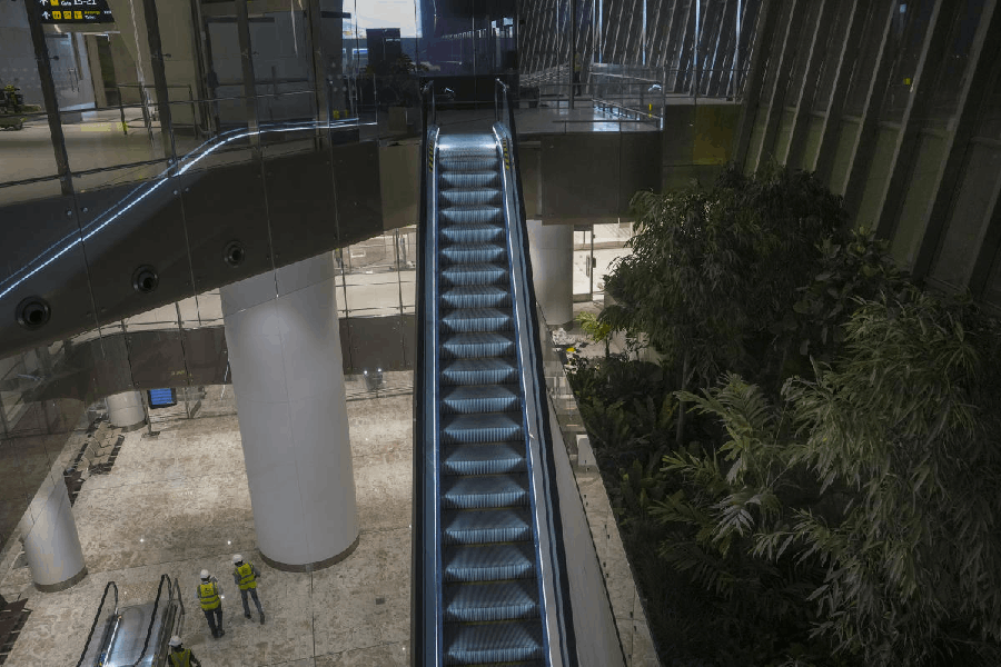 Worker at the Navi Mumbai International Airport, in Navi Mumbai, Wednesday, Dec. 17, 2025. Adani Group plans to invest Rs 1 lakh crore in its airports business over the next five years, betting on sustained growth in India's aviation sector, which is expected to expand at 15-16 per cent annually, a top group official said.