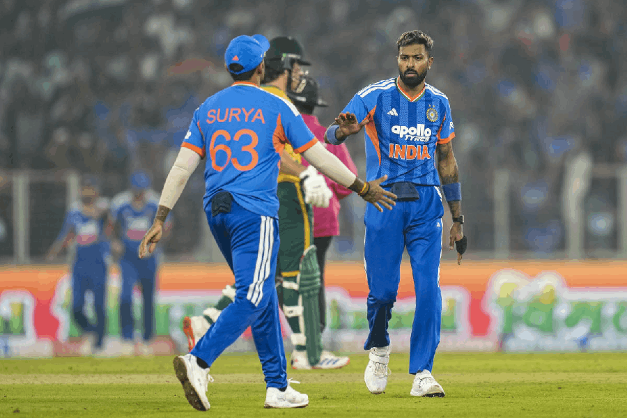 India's captain Suryakumar Yadav with teammate Hardik Pandya celebrates the wicket of South Africa's Dewald Brevis during the fifth T20 International cricket match of a series between India and South Africa, at Narendra Modi Stadium in Ahmedabad, Friday, Dec. 19, 2025.
