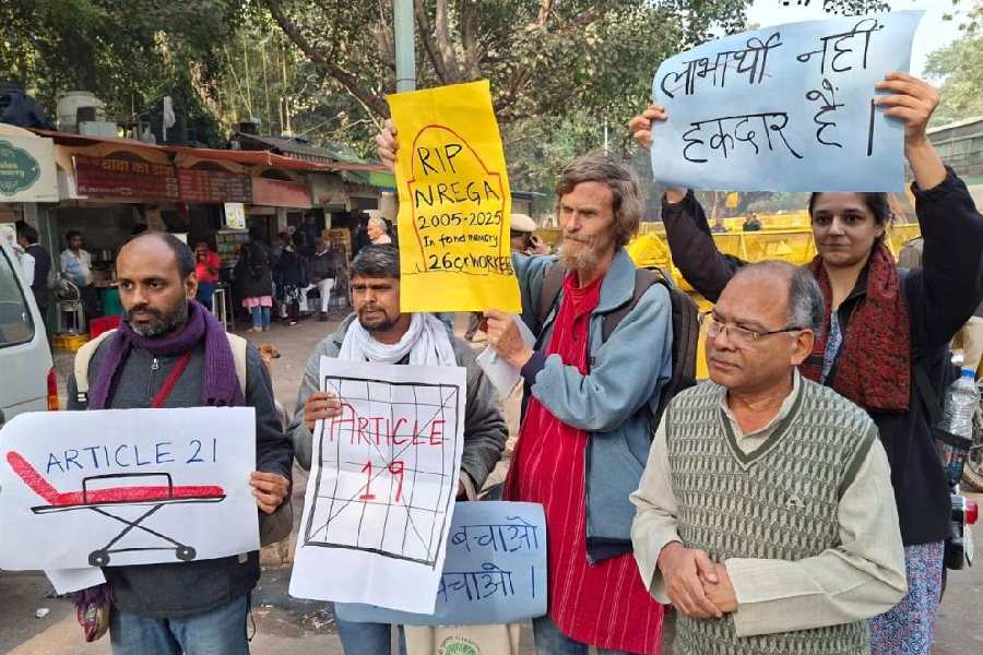 Economist Jean Dreze (in red kurta) and others protest against the VB-G RAM G Bill on Jantar Mantar Road in New Delhi on Friday.