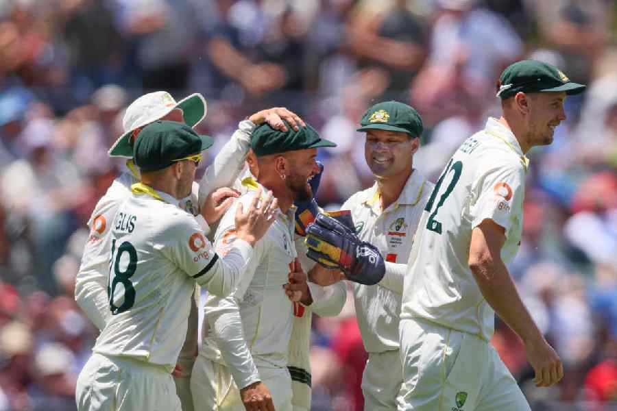 Australia's Jake Weatherald, centre, celebrates with his teammates after taking catch to dismiss England's Jofra Archer during play on the final day of the third Ashes cricket test between England and Australia in Adelaide, Australia, Sunday, Dec. 21, 2025.