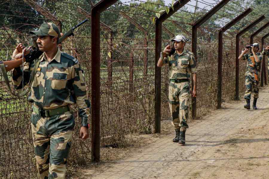 Border Security Force (BSF) personnel patrol along the India-Bangladesh border, on the outskirts of Agartala, Tripura