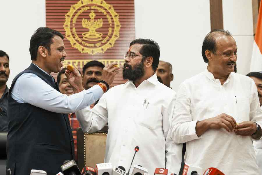 Maharashtra Chief Minister Eknath Shinde with Deputy Chief Ministers Devendra Fadnavis and Ajit Pawar celebrates during a press conference as the BJP-led Mahayuti alliance secures victory amid the counting of votes for the Maharashtra Assembly elections, in Mumbai
