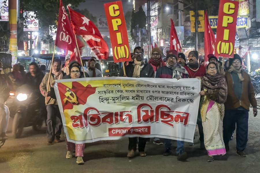 CPI(M) workers take out a rally through Krishnanagar protesting alleged atrocities against minority Hindus in Bangladesh and demanding intervention by Prime Minister Narendra Modi, in Nadia, Sunday, Dec. 21, 2025.
