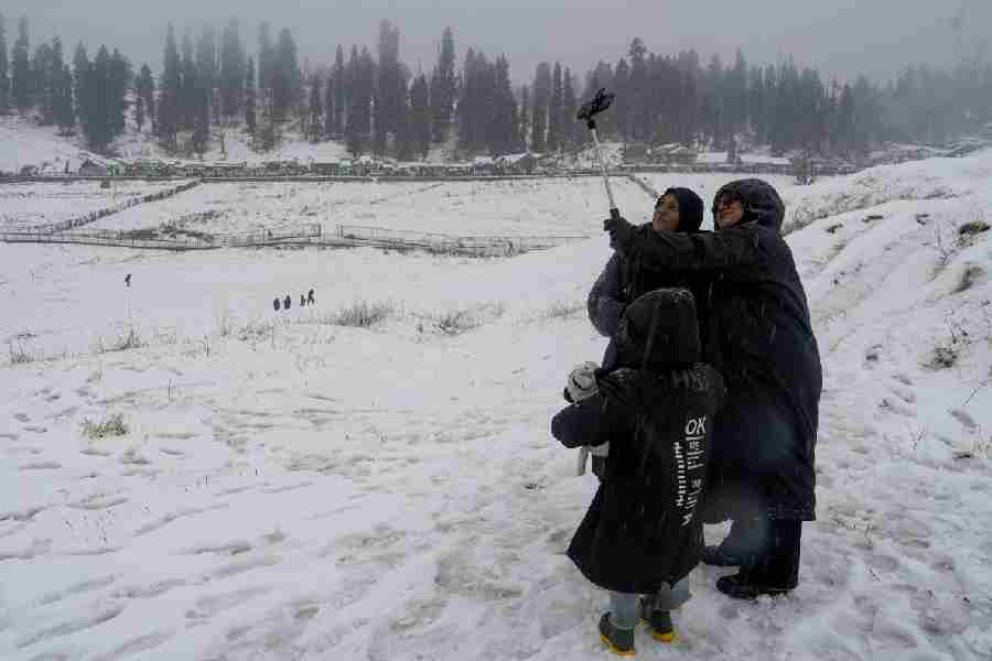 Tourists click a selfie in Gulmarg on Sunday.