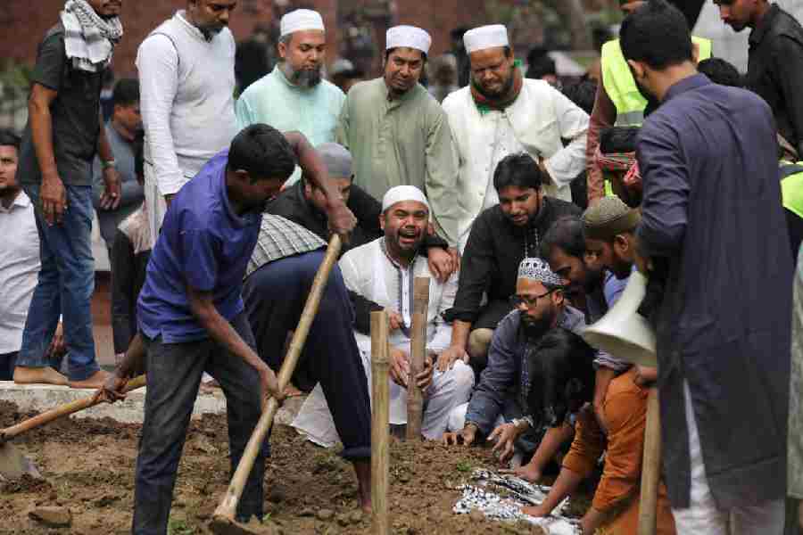 Omar Faruk, Sharif Osman Hadi’s brother, mourns during the burial in Dhaka on Saturday.