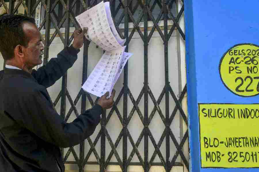 A voter checks the draft electoral rolls for his name in Siliguri on December 19.