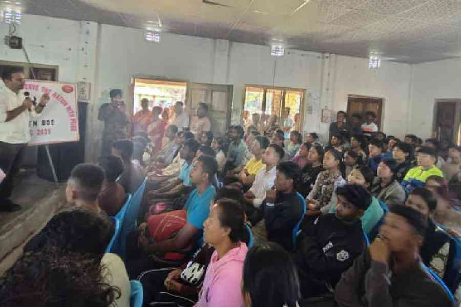 Parveen Kaswan (left), the divisional forest officer of Jaldapara wildlife division, speaks to youths at the awareness camp at Kodalbusty in Alipurduar district on Friday