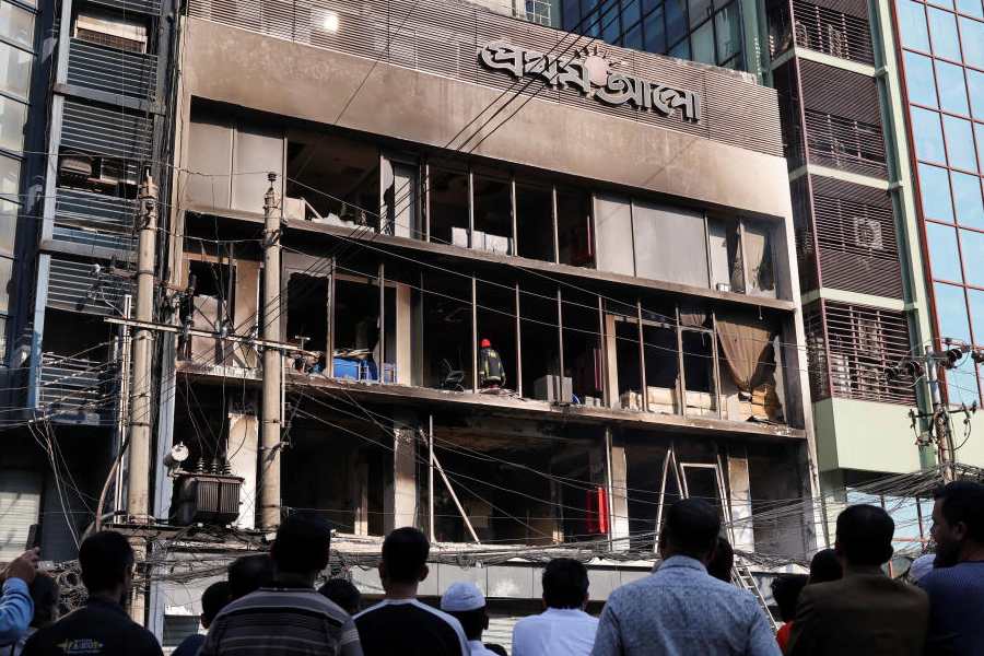 People gather to look at the building of the vandalised office of Prothom Alo newspaper, following the death of Sharif Osman Hadi, a student leader, who was undergoing treatment in Singapore after being in shot the head, in Dhaka, Bangladesh, December 19, 2025.