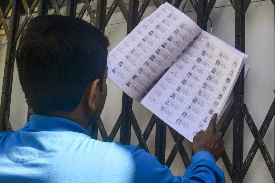 A voter checks his name from West Bengal's draft electoral rolls following special intensive revision (SIR), in Siliguri, West Bengal, Friday, Dec. 19, 2025.