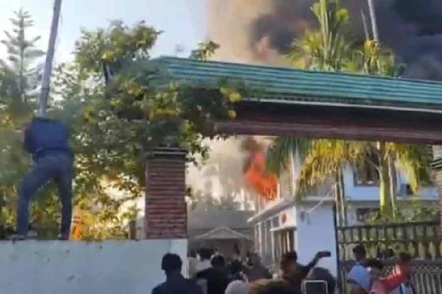 Flames visible at the residence of Dr Tuliram Ronghang in Artukekang, Assam, on Monday