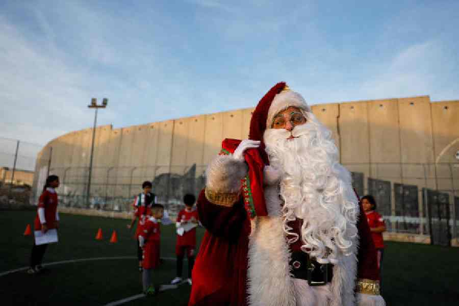 A man dressed as Santa with Palestinian children in Bethlehem on Monday.