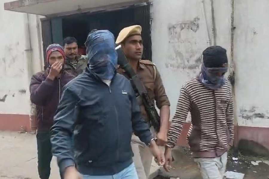Two of the convicts (faces masked) in the murder of Samserganj residents Haragobinda Das and Chandan Das being taken to the court at Jangipur in Murshidabad on Tuesday.